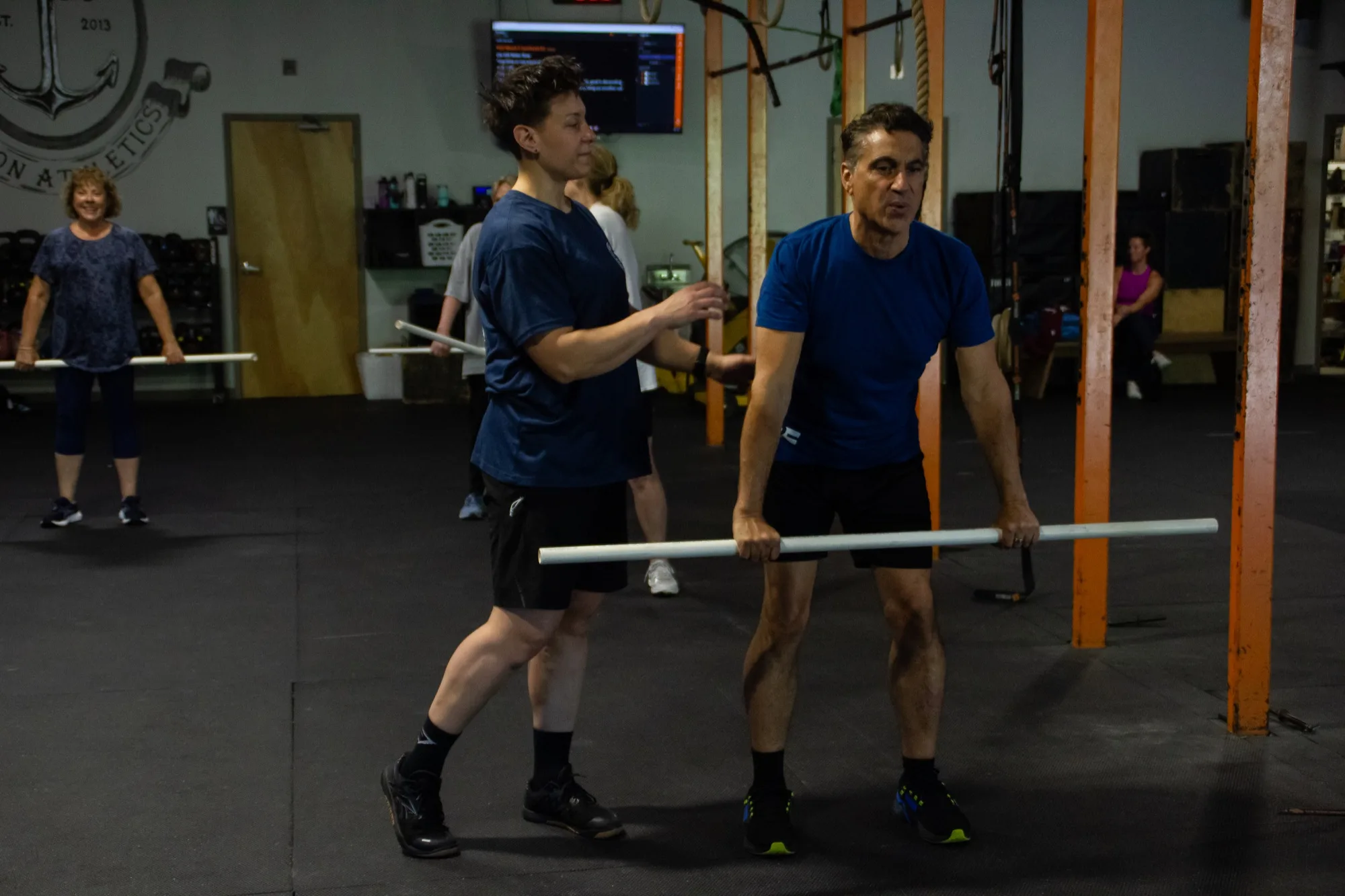 A Top Form coach gives hands-on form coaching to a client in Branford, CT
