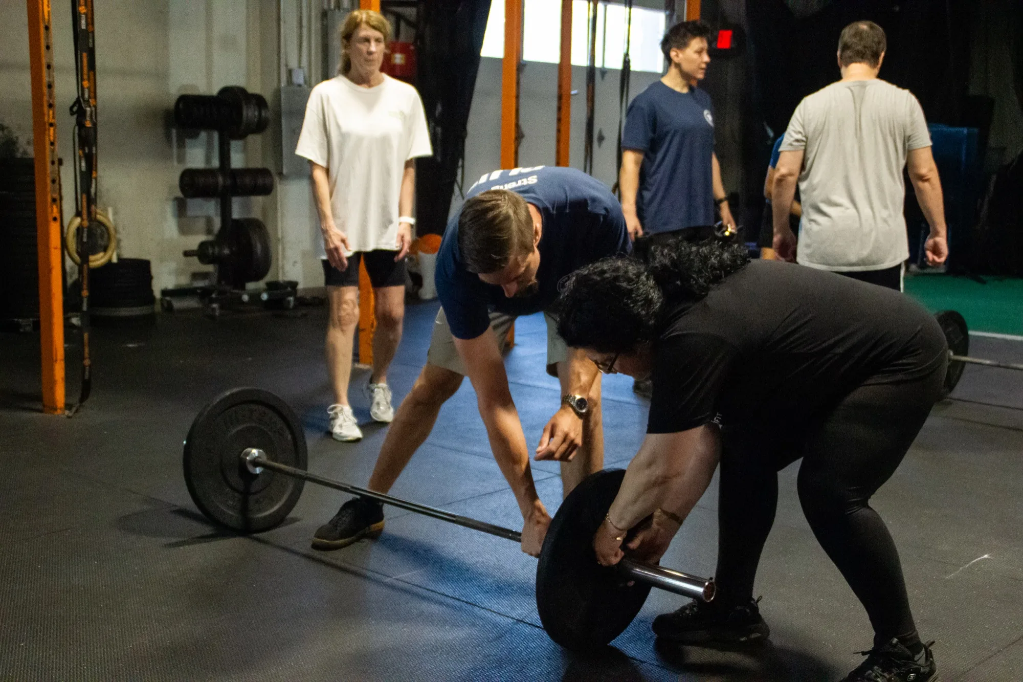 A Top Form physical therapist coaches a client through a barbell deadlift in Branford, CT